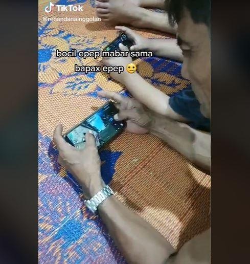 Bapak yang main game FF sama anak ini bikin netizen salfok. (TikTok/ @renandanainggolan)